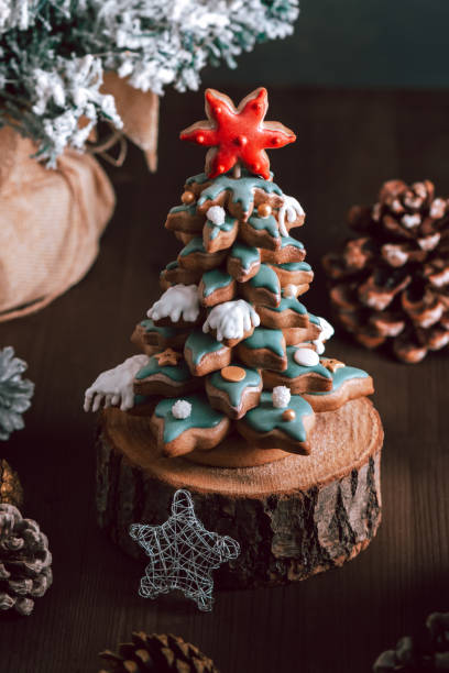 istock Gingerbread Christmas tree on dark table, Christmas card 1355540102