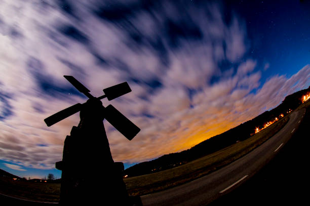 Old windmill in sunset and dramatic cloudscape Small very old windwill during sunset in Sweden storm cloud sky dramatic sky cloud stock pictures, royalty-free photos & images