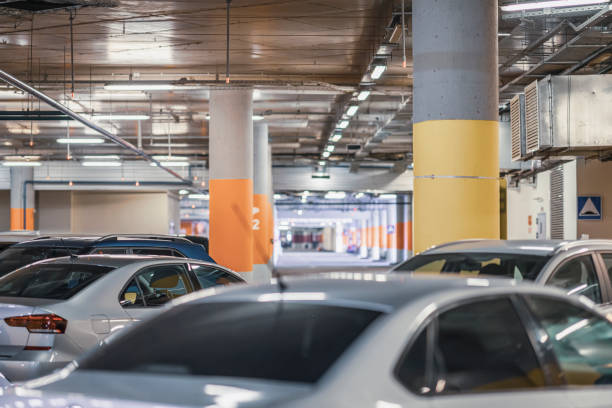istock Abstract blurred Parking garage, cars in underground interior 1355548658