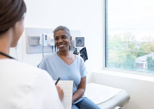 istock Doctor Talking with a Senior Patient 1355549910