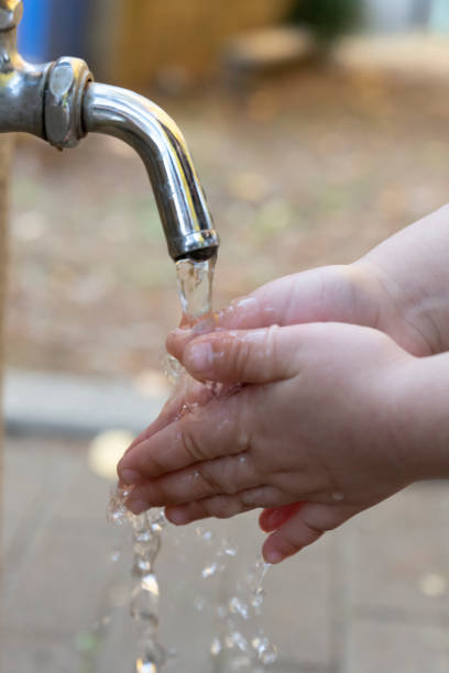 istock Washing hands with a faucet 1355549943