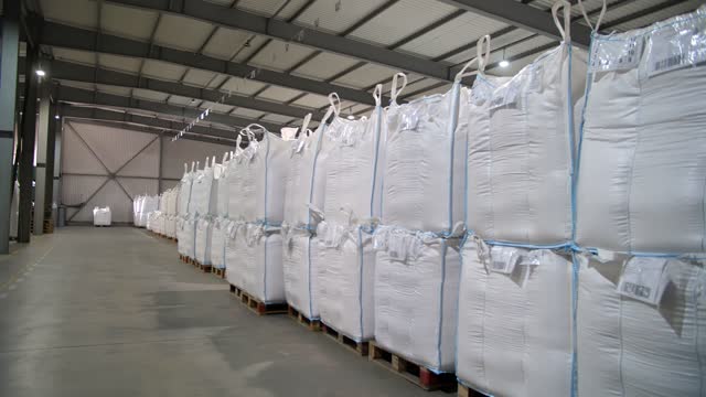 agricultural storage. warehouse. bags of corn seed, grain. large warehouse of agricultural enterprise for seeds procurement and storage