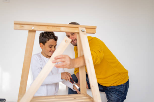 istock Father and son assembling made furniture 1355550733