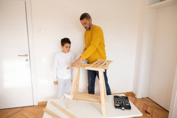 istock Father and son assembling made furniture 1355550787