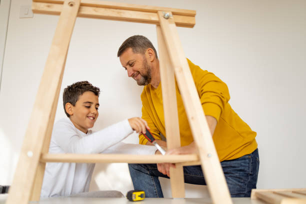 istock Son assembling furniture with father 1355551324