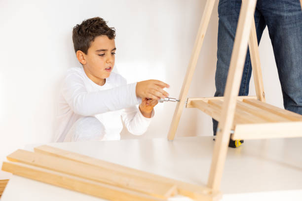istock Young carpenter screws made furniture 1355551437