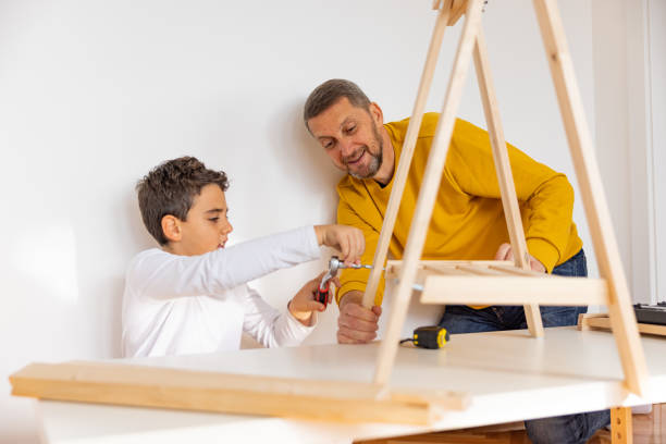 istock Son assembling furniture with father 1355551563