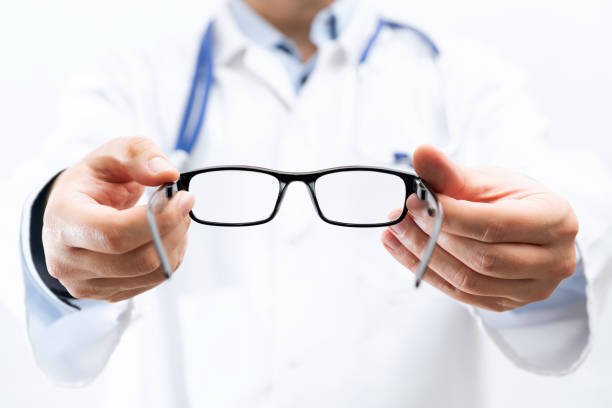 istock Optometrist holds glasses to try on 1355553105