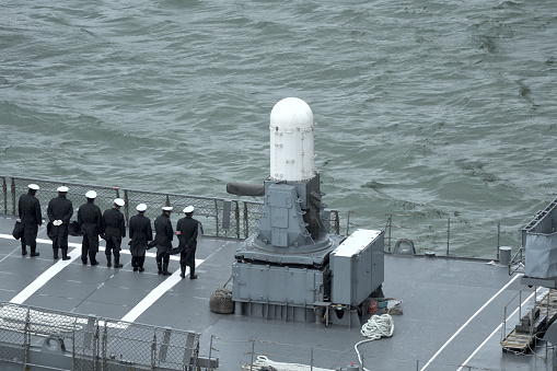 Navy frigate moored at naval dockyard.