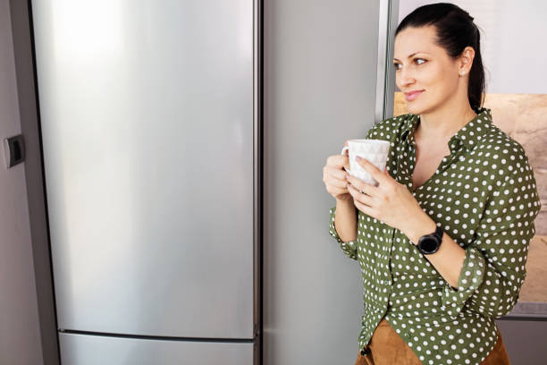 istock Woman Holding a Cup of Coffee 1355554113