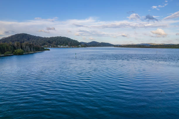 istock Late afternoon waterscape with boats and rain clouds 1355557177