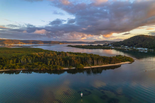 istock Aerial sunrise over the bay with clouds and reflections 1355557835