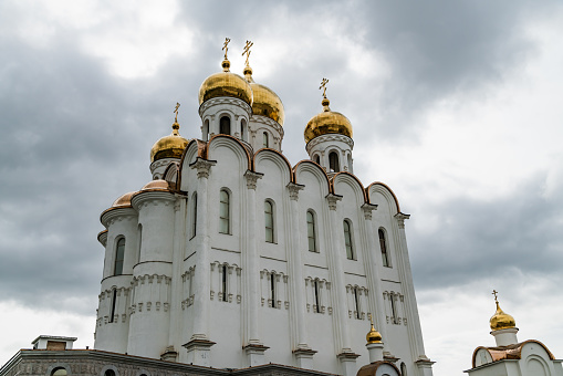Blue domes of Holy bogolyubovsky monastery against cloudy sky