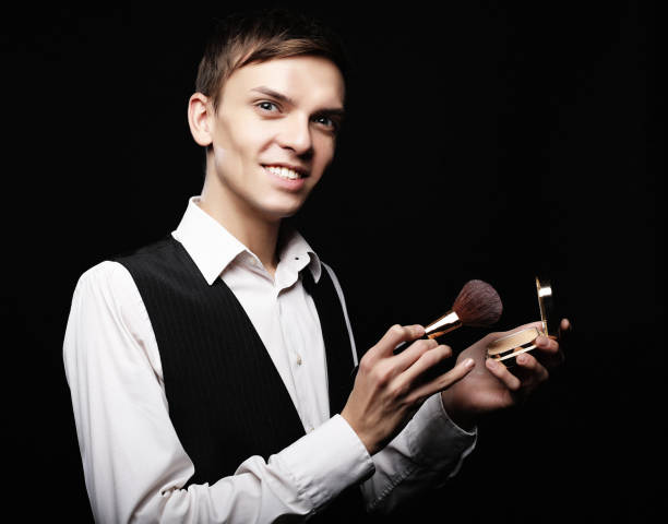 young male make up artist posing with foundation for make-up o - male beauty male 2000 style imagens e fotografias de stock