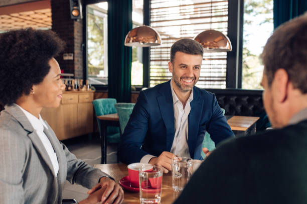 istock Colleagues talking about business with coffee 1355563737