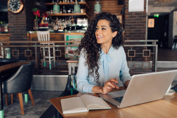 istock Businesswoman enjoying working from the cafe 1355563770