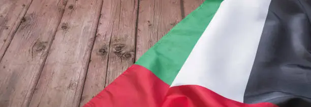 Photo of Flag of the United Arab Emirates and place for text on a dark wooden background