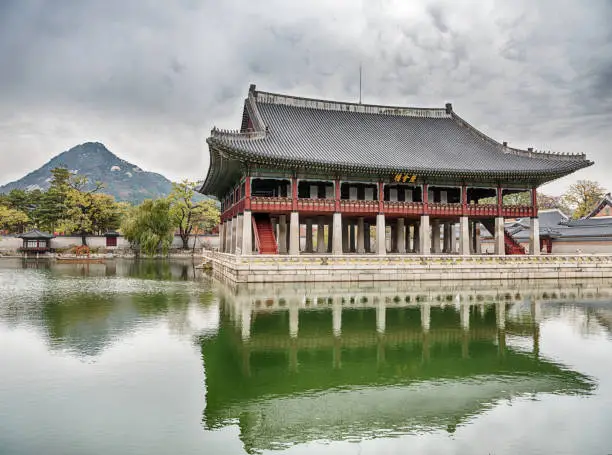 The Gyeonghoeru pavilion is located next to a pool of water in the Gyeongbokgung royal palace complex in Seoul, South Korea.