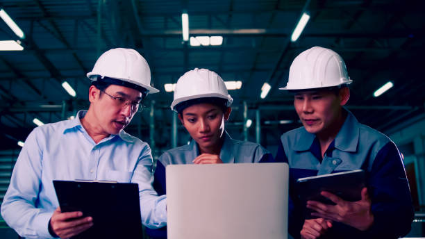 istock A team of engineers is explaining remote machine control to industrial owners. 1355569546