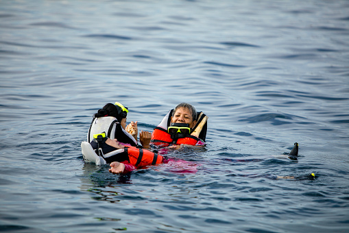 asian people snorkel in the sea