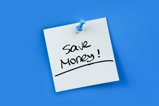 istock Save money written on white sticker note over blue background 1355578110
