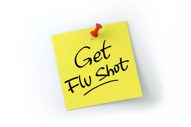 get flu shot written on yellow sticker note over white background - calendar calendar date reminder thumbtack imagens e fotografias de stock