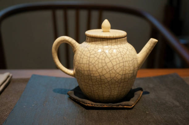 istock Interior Chinese tea space with a white Jun kiln teapot on the tea table. Very Zen-like. Chinese style tea room space.Tea ceremony.Selective focus. 1355579155