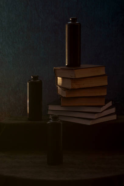 istock Still life with books and black bottles 1355583935