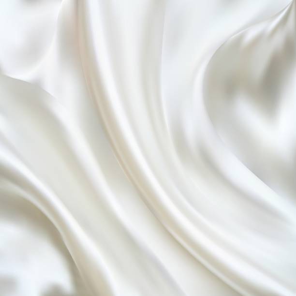istock White Satin Silky Cloth,Fabric Textile Drape with Crease Wavy Folds.with soft waves,waving in the wind.Texture of crumpled paper. Milk,Yogurt,Cream or cosmetics product Curl background. eps 10 1355584732