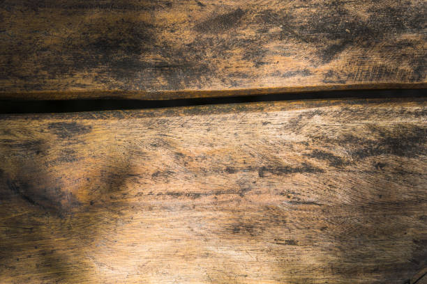 istock Wooden table with cut in the middle. Located in a park with natural light. Some shadows from the trees. Top view. 1355586510