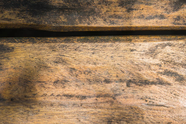 istock Wooden table with cut in the middle. Located in a park with natural light. Some shadows from the trees. Top view. 1355586514