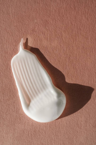 istock The texture of the white cream on a pink background. 1355587065