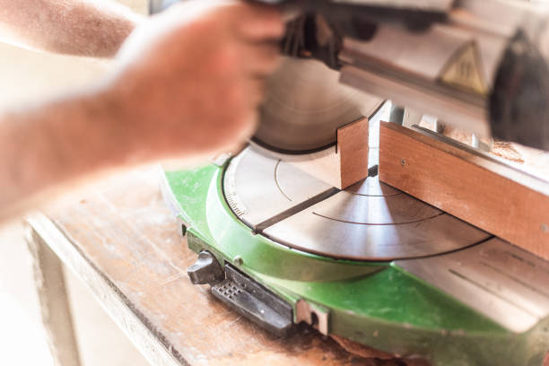 istock miter saw in motion, blurred hand in foreground 1355587799
