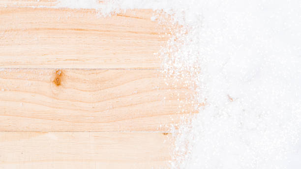 istock Table snow. Winter wooden texture background. Christmas board with old rustic wood wall, white frozen ice. Merry Christmas holiday card pattern. 1355592540