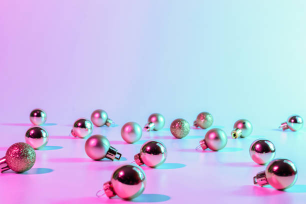 istock Christmas balls pattern neon background. Xmas bauble on abstract holiday winter gradient backdrop. Happy new year copy space. 1355597653