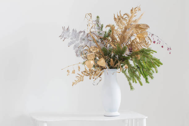 istock christmas bouquet in white vase on white background 1355598278