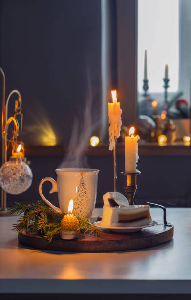 hot drink with cake and christmas decorations  on white table in kitchen