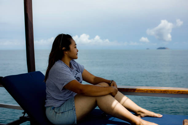 istock Woman Sitting On Boat In sea 1355598445