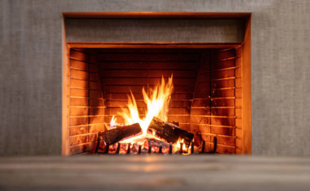 istock Fireplace burning firewood, fire flames on wood logs, bricks background. Cozy warm home at Christmas 1355602769