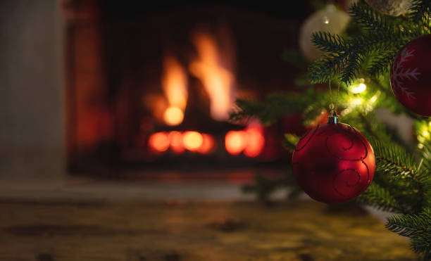 istock Christmas tree and burning fireplace background. Wooden table desk empty, template 1355602787