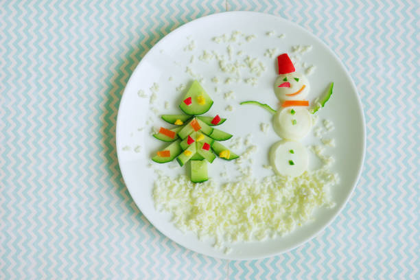 Snowman, christmas tree made of food. Funny decorated dish
