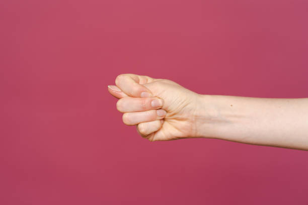 istock Women hand showing stop sign on a pink background 1355604802