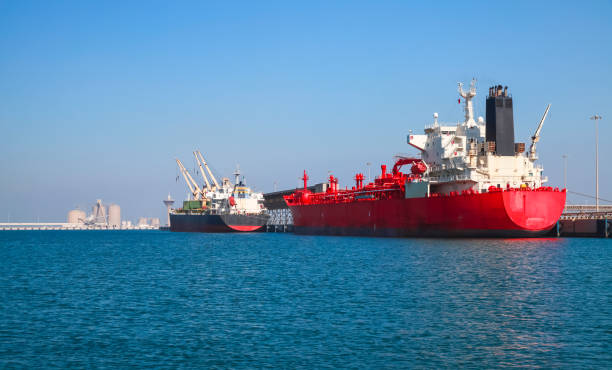Red tanker ship is loading in port of Saudi Arabia, stern view stock photo