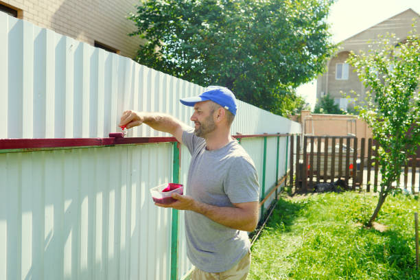 istock Man painting fence. Working process 1355605306