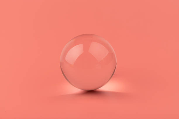 istock Crystal glass ball sphere transparent on pink background. 1355606390