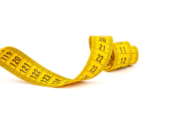 istock Yellow measuring tape spiral, isolated on white background. 1355606445
