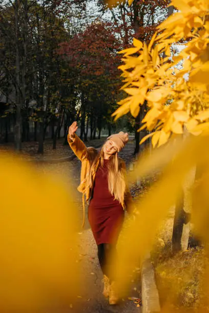 Vitamin D in autumn and winter season. Vitamin D in Womens Health, Role of Vitamin D3 Supplements in female health. Young woman enjoying sun in fall nature background.