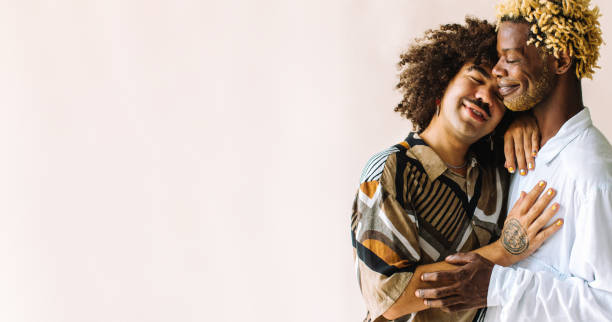 istock Two young male lovers embracing each other in a studio 1355608826