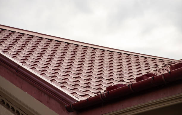 istock New roofing construction with attic skylights, rain gutter system, roof windows and roof protection from snow board, snow guard exterior. 1355610215