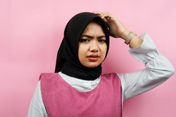 Closeup of beautiful young muslim woman thinking, stressed, isolated stock photo